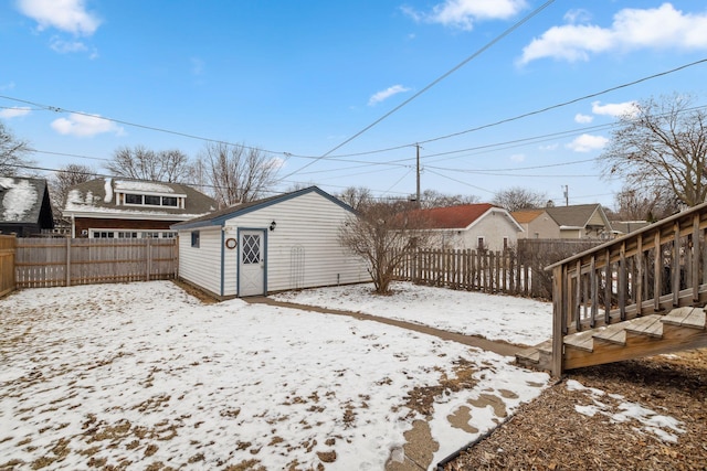 yard layered in snow with an outbuilding