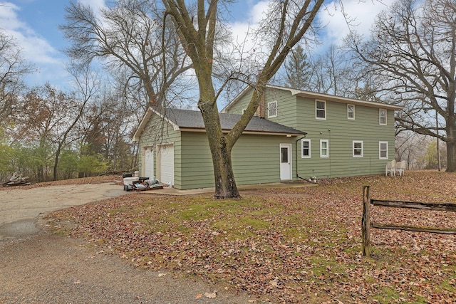 back of house with a garage