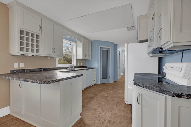 kitchen featuring white appliances, white cabinetry, and sink