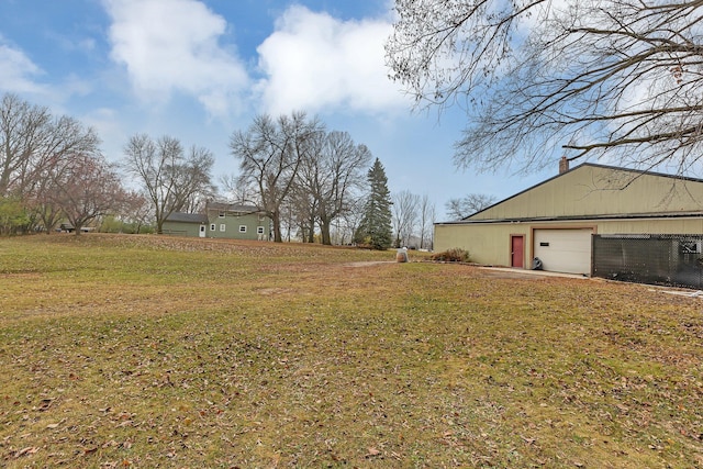 view of yard featuring an outbuilding and a garage