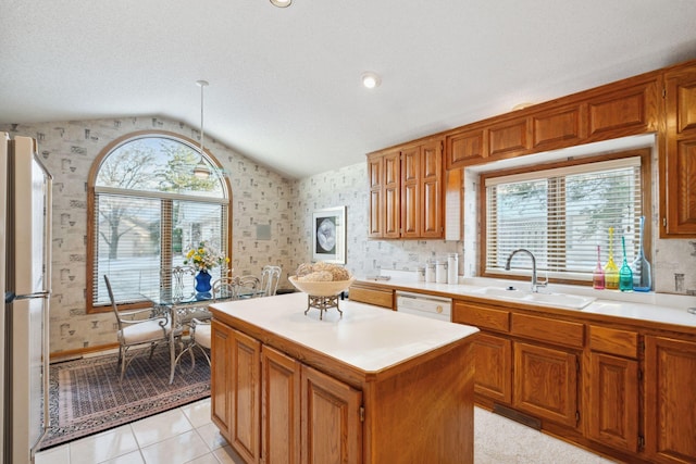 kitchen featuring a kitchen island, lofted ceiling, sink, and a wealth of natural light