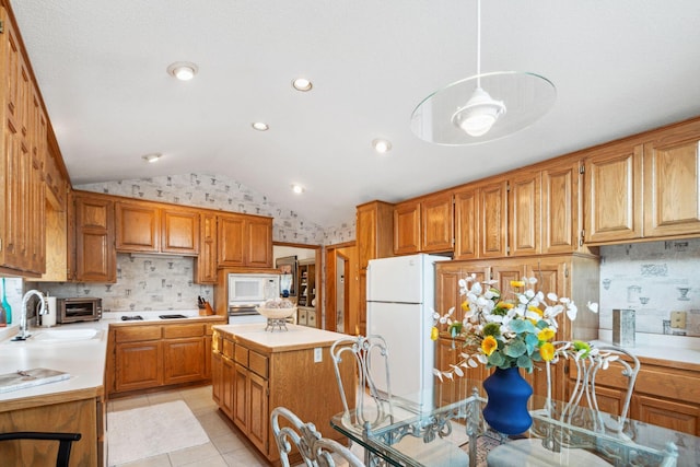 kitchen with sink, light tile patterned flooring, lofted ceiling, white appliances, and a kitchen island