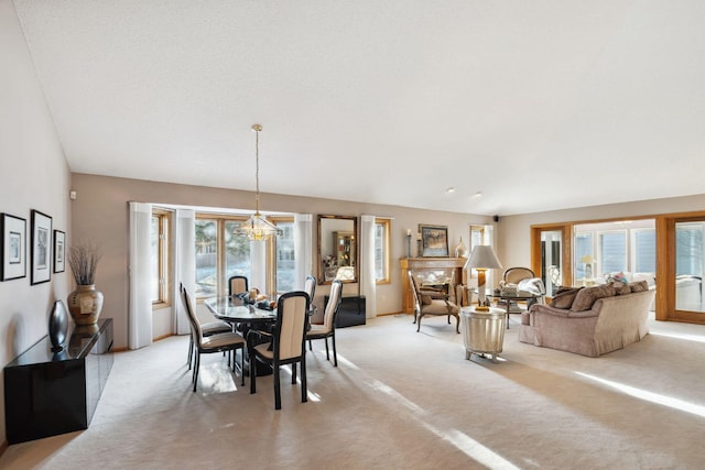 dining space featuring a notable chandelier and light colored carpet