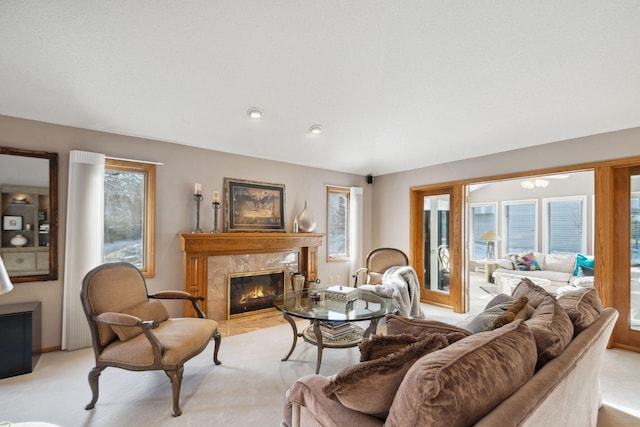 carpeted living room featuring plenty of natural light and a high end fireplace