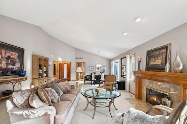 living room featuring light carpet, a high end fireplace, and vaulted ceiling