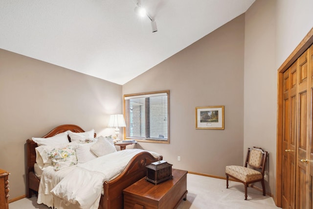 bedroom featuring light colored carpet, high vaulted ceiling, and a closet