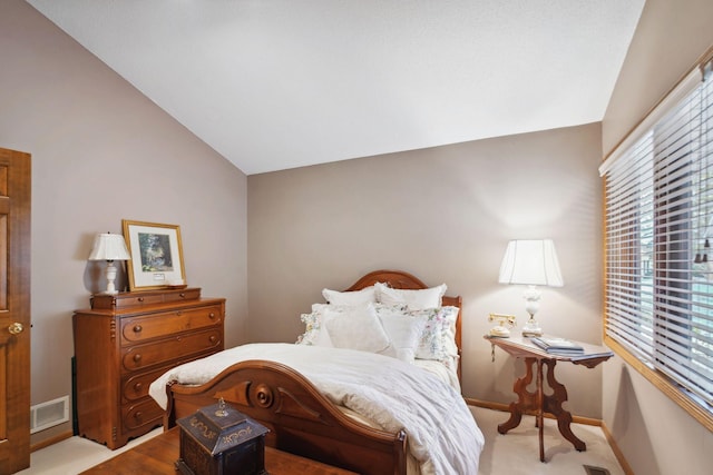 carpeted bedroom with vaulted ceiling