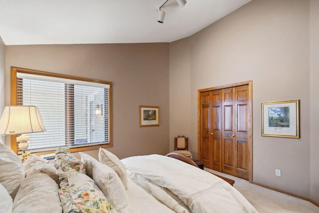 bedroom featuring carpet, lofted ceiling, and a closet