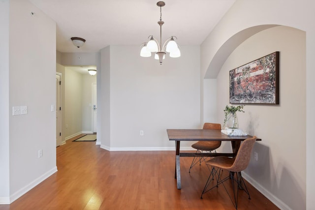 dining room with a notable chandelier and hardwood / wood-style flooring