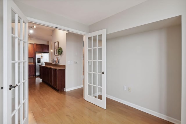 interior space with light hardwood / wood-style floors and french doors