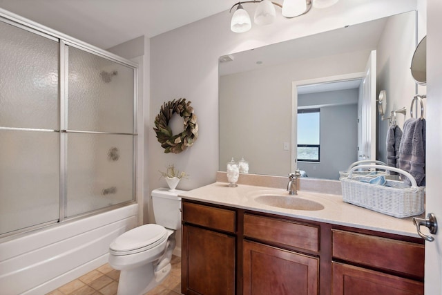 full bathroom featuring toilet, combined bath / shower with glass door, and vanity