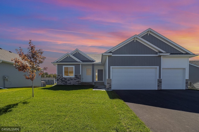 craftsman-style house with a garage and a lawn