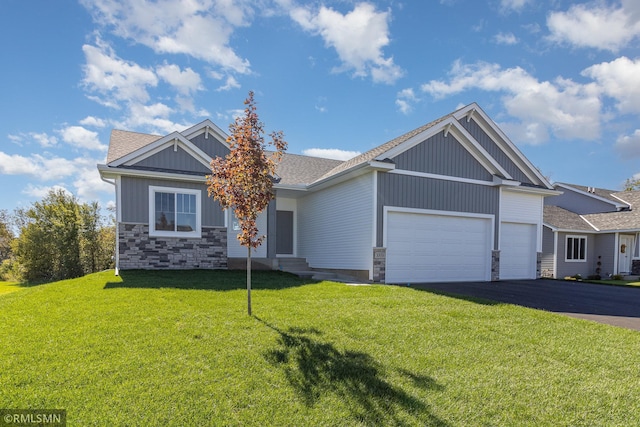 craftsman-style home featuring a front lawn and a garage