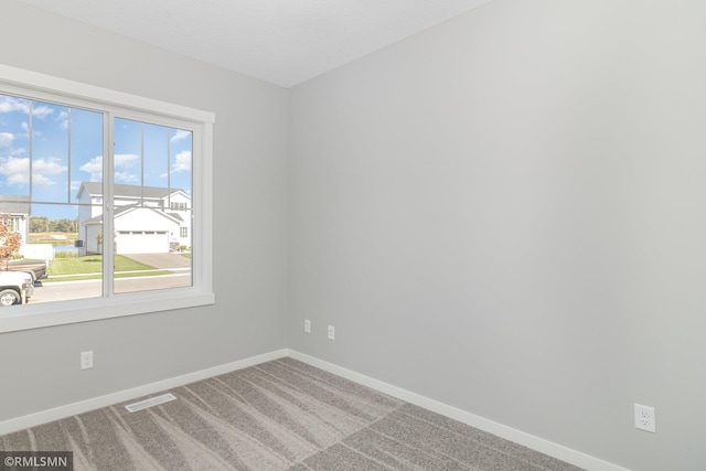 carpeted empty room featuring a healthy amount of sunlight