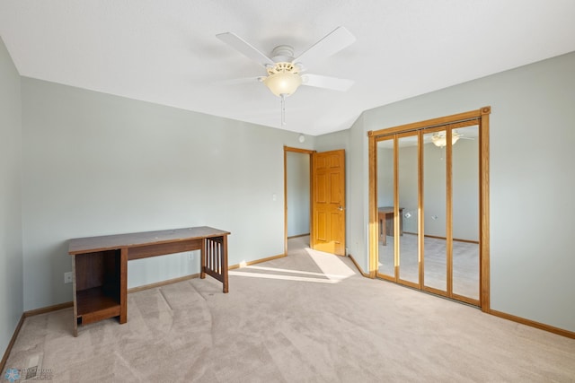 carpeted empty room featuring ceiling fan