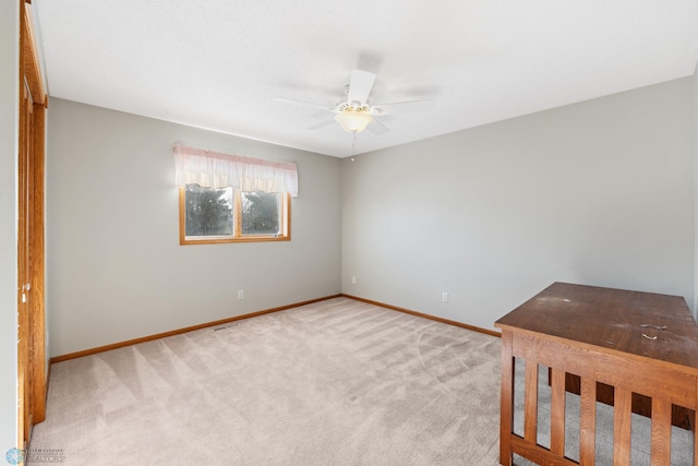 unfurnished bedroom with ceiling fan and light carpet