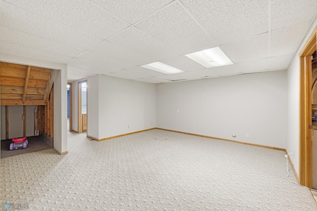 basement featuring a drop ceiling and carpet floors