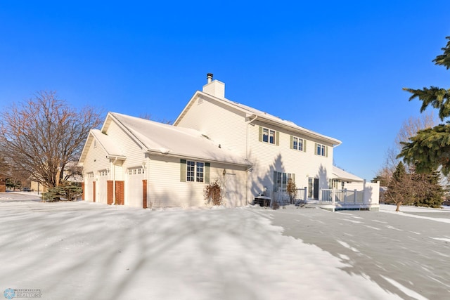 rear view of house featuring a garage