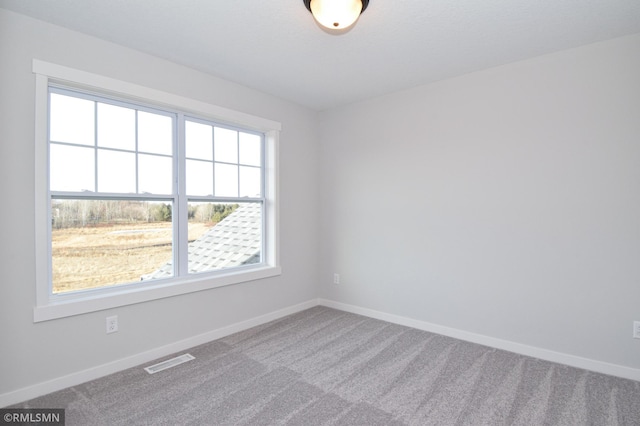 unfurnished room featuring carpet