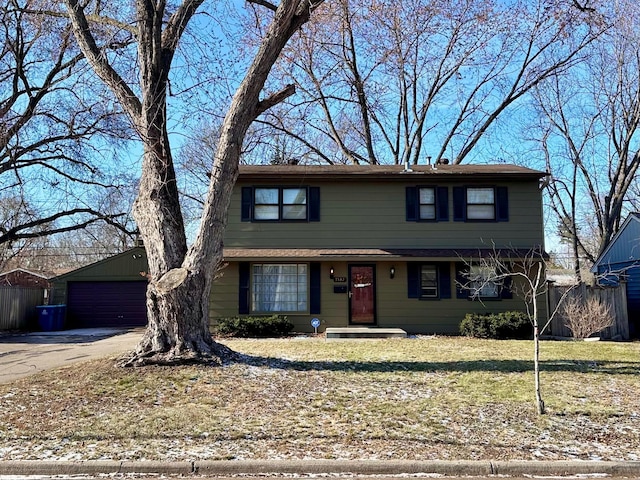 front facade featuring a garage and an outbuilding