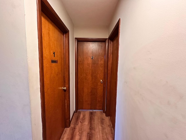 corridor with dark hardwood / wood-style flooring