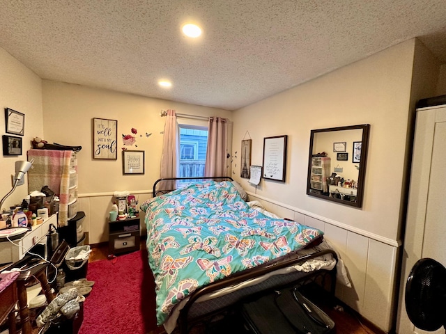 carpeted bedroom with a textured ceiling