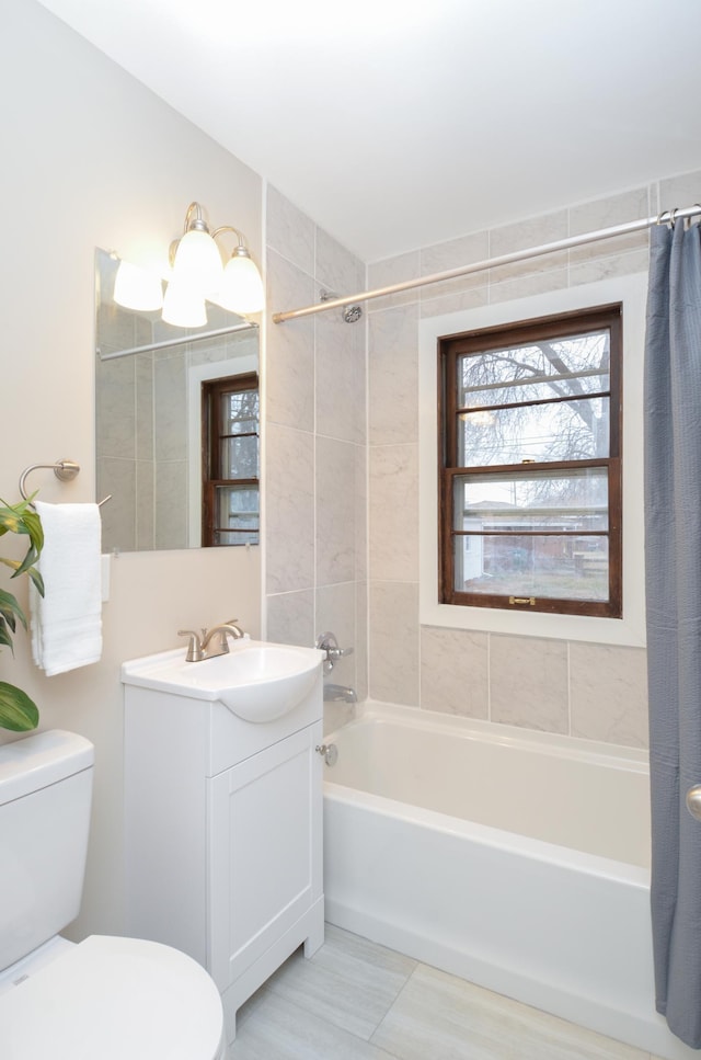 full bathroom with tile patterned flooring, shower / tub combo, vanity, and toilet