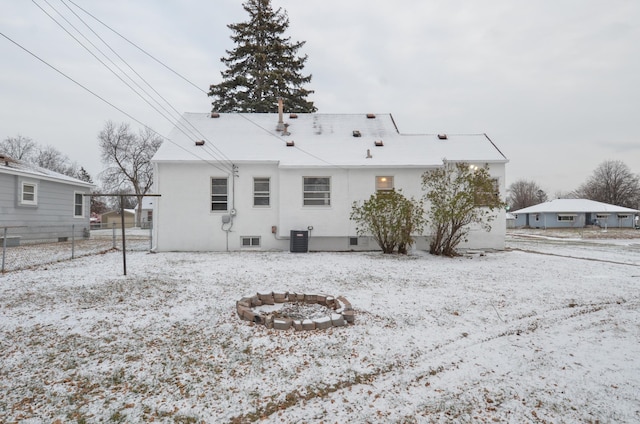 snow covered property featuring central AC unit