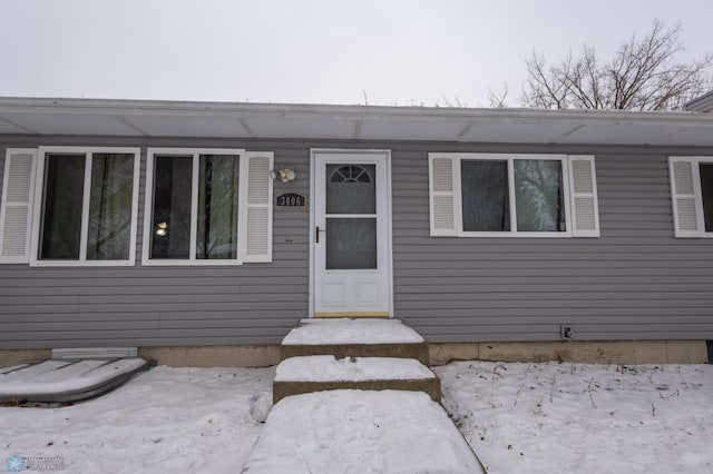 view of snow covered property entrance