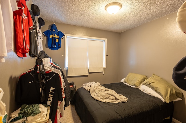 bedroom with carpet and a textured ceiling