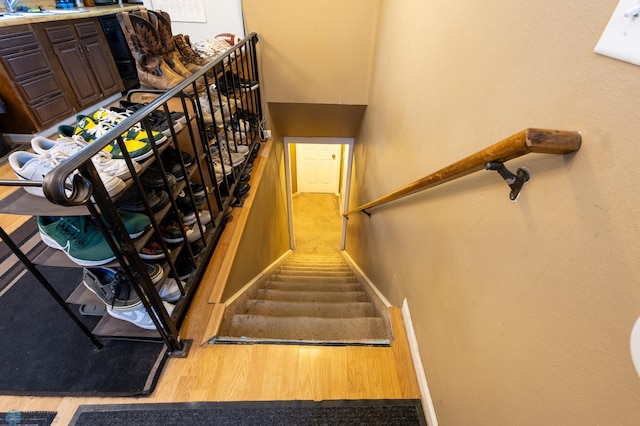 stairs featuring hardwood / wood-style floors