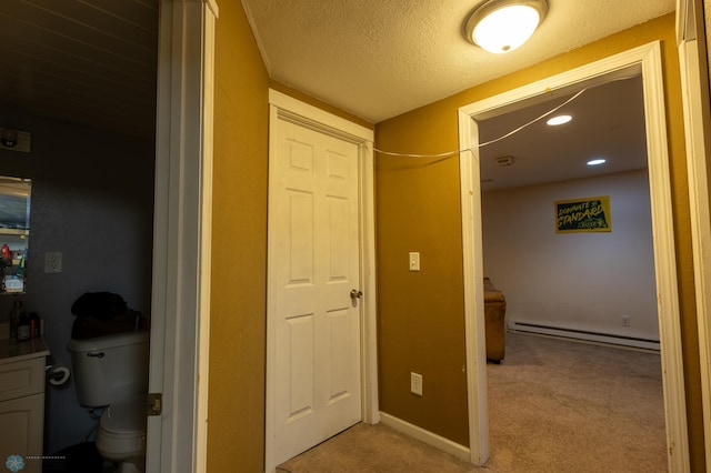 bathroom featuring baseboard heating, a textured ceiling, and toilet