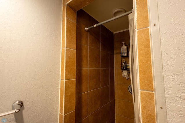 bathroom with tiled shower