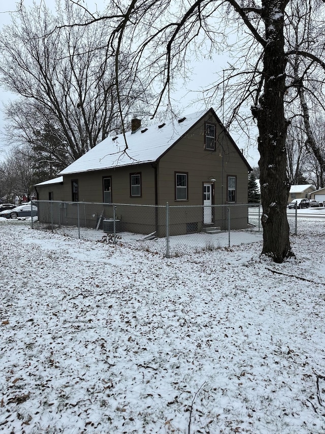 view of snow covered back of property