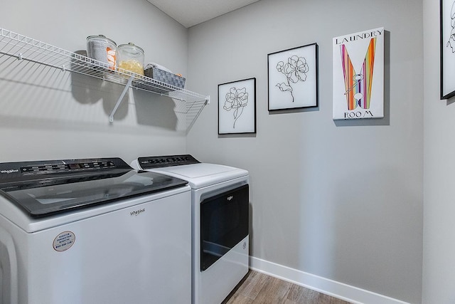 washroom featuring hardwood / wood-style floors and washing machine and clothes dryer