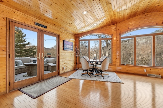 sunroom / solarium featuring french doors, vaulted ceiling, and a wealth of natural light