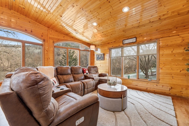 living room featuring wooden walls, wood ceiling, vaulted ceiling, and light wood-type flooring