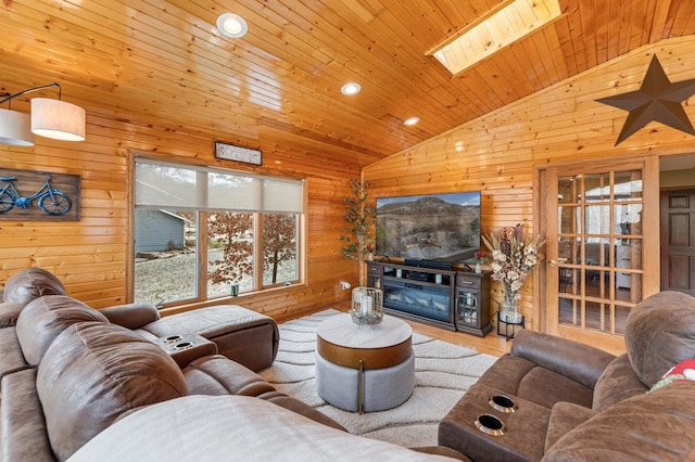 living room featuring a skylight, wood walls, hardwood / wood-style floors, and wood ceiling