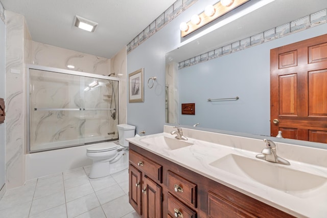 full bathroom with toilet, vanity, tile patterned floors, and enclosed tub / shower combo