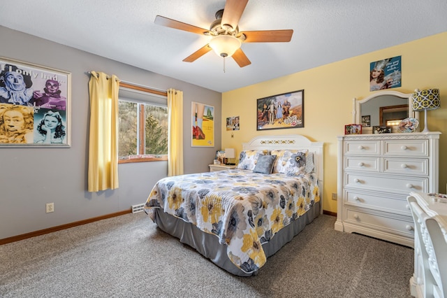 carpeted bedroom featuring ceiling fan and a textured ceiling