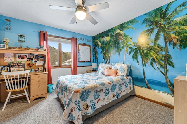 bedroom with ceiling fan, carpet floors, and a textured ceiling