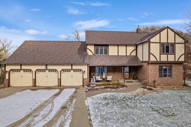 tudor-style house featuring a garage