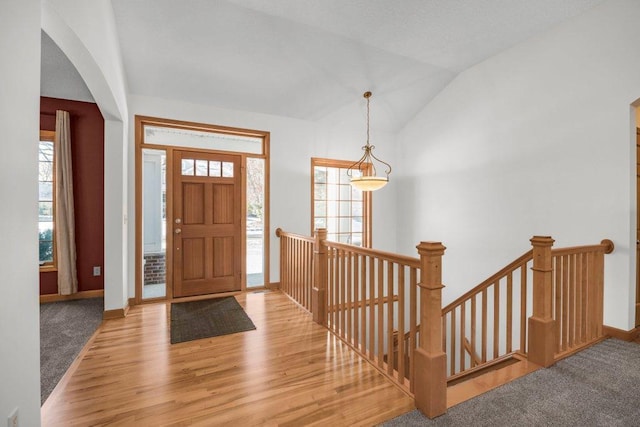 entryway with light wood-type flooring and lofted ceiling