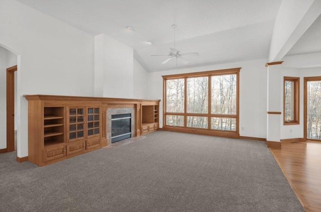 unfurnished living room with hardwood / wood-style flooring, ceiling fan, and lofted ceiling