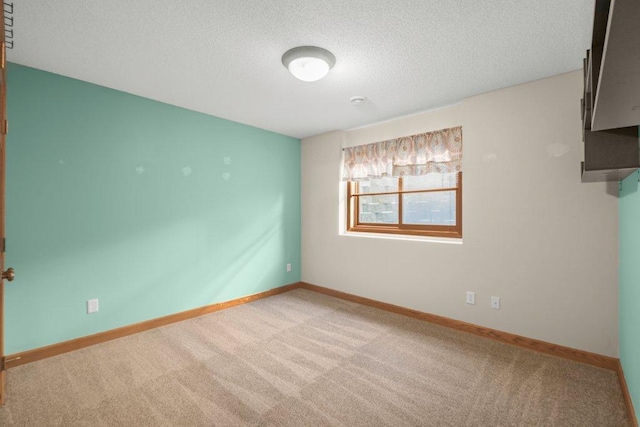 spare room with carpet floors and a textured ceiling