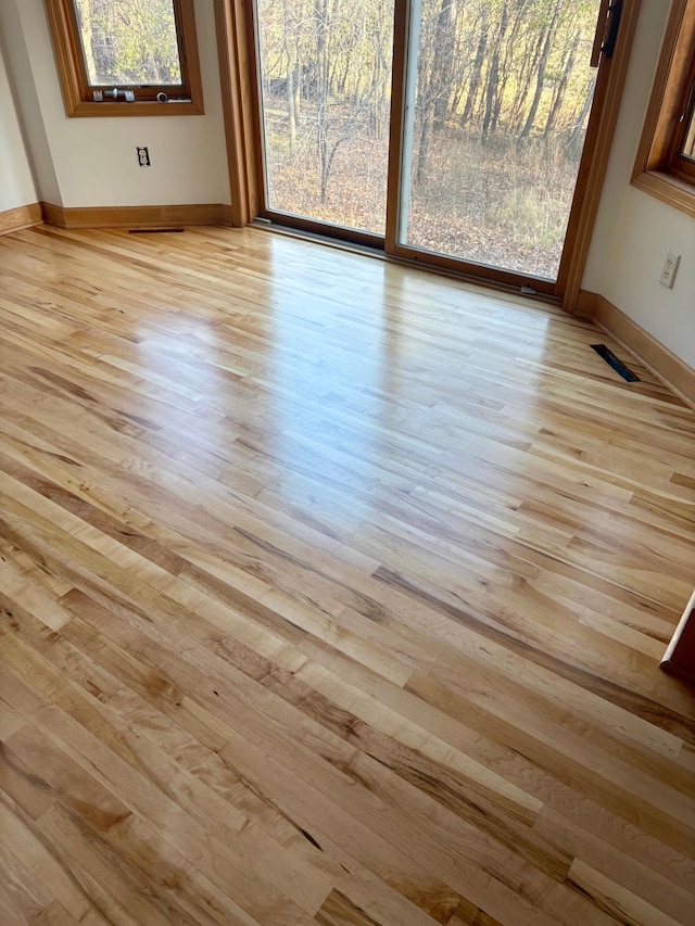 spare room featuring light hardwood / wood-style floors