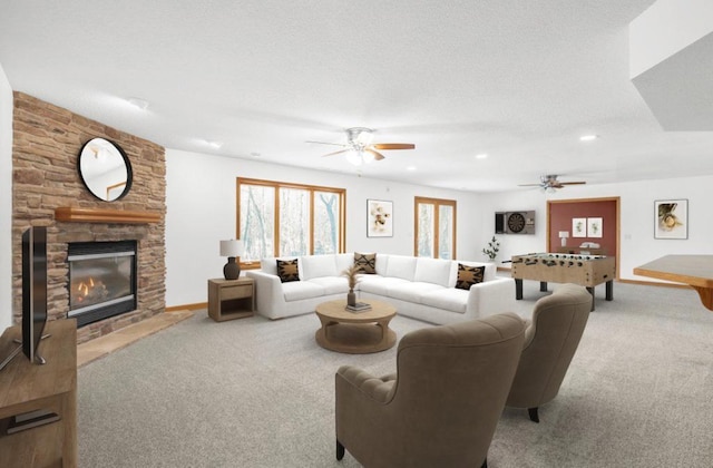 carpeted living room featuring ceiling fan and a fireplace