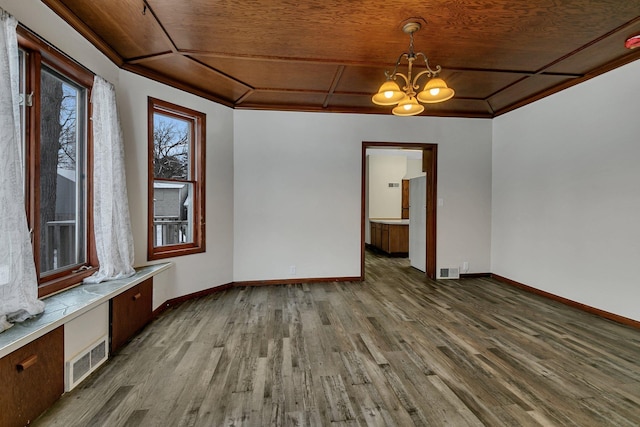 interior space featuring crown molding, dark wood-type flooring, and a chandelier