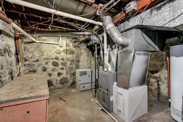 utility room featuring heating unit and gas water heater