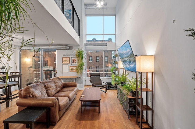 living room featuring a towering ceiling and wood-type flooring